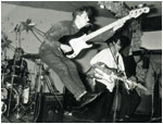 BASH OUT THE ODD at "Graysons" in Nuneaton some time in 1989. It's an amusing action shot with Mark Mortimer in full leaping Pete Townshend mode!! Also shown is Stu Pickett on drums, Mark Brindley on rhythm guitar and Pete Woodward on lead guitar.