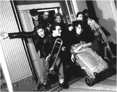 February 1989 pic: Nuneaton photographer Matt Page. Line up is (clockwise from rear left): Mark Mortimer (bass), Mark Allison (trumpet), Stuart Pickett (drums), Martin Cooper (trumpet, Eb trumpet), mannequin, Mark Brindley (vocals, guitar), Bryan Hurdley (trombone), Julian Amos (guitar, vocals).