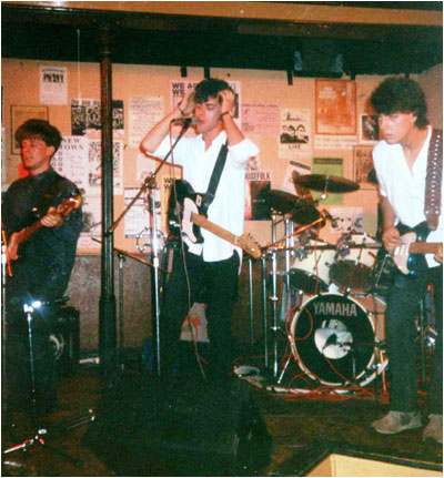 Bash Out The Odd playing live in their final line up at The Stage Door in Scarborough, July 1990. It shows L-R: Mark Mortimer (bass), Mark Brindley (guitar and vocals), Stuart Pickett (drums), Paul Whitehead (lead guitar).
